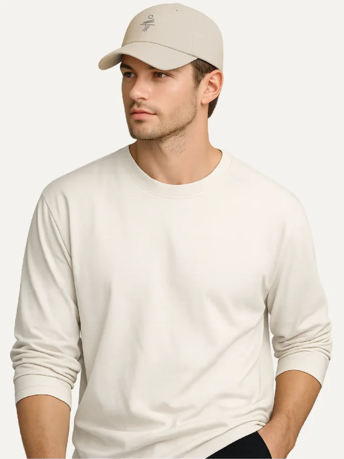 person wearing oyster organic cotton cap with minimal solar current embroidery