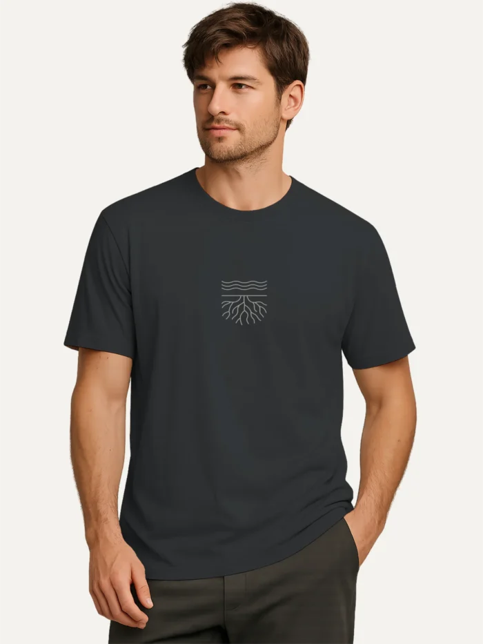 Male model wearing india ink grey organic cotton t-shirt with minimal surface and root line artwork in stone grey ink
