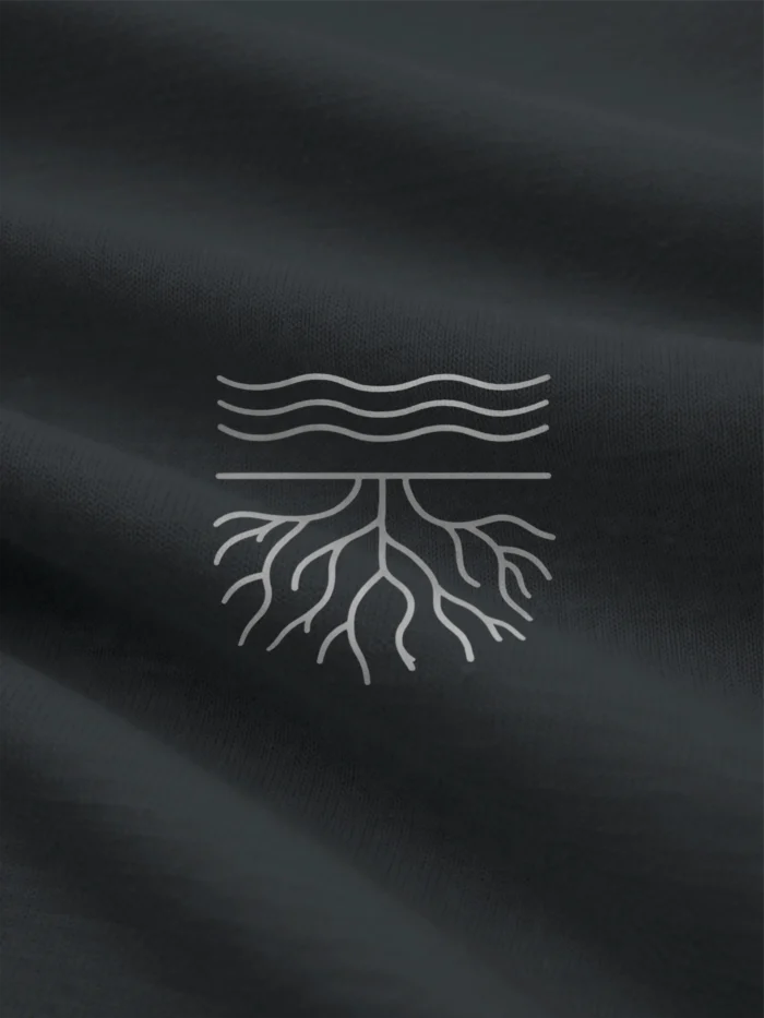 Close-up of stone grey root line artwork printed on india ink grey organic cotton fabric