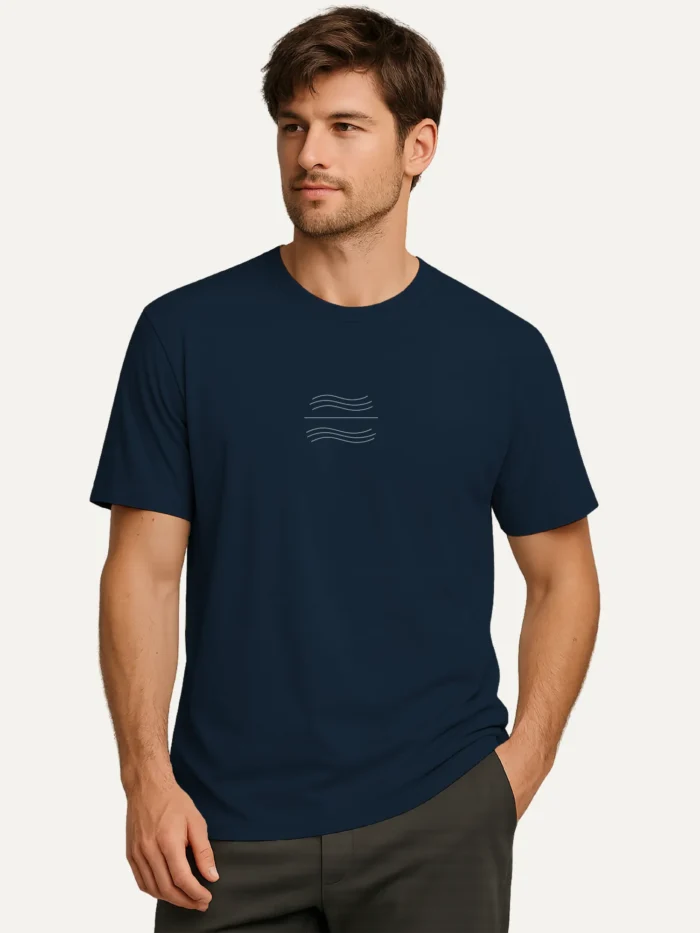 Male model wearing french navy organic cotton t-shirt with minimal tidal balance wave symbol
