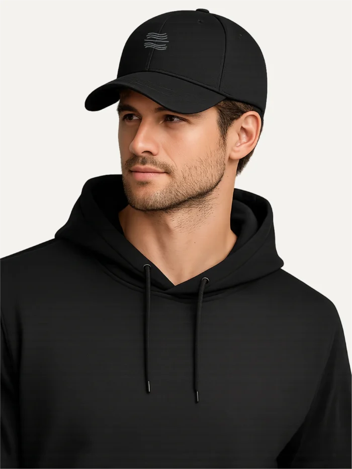 male model wearing black organic cotton twill cap with tidal balance embroidery