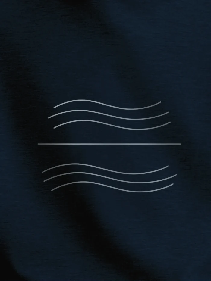 Close-up of Tidal Balance tidal line artwork printed in stone grey on French navy organic sweatshirt
