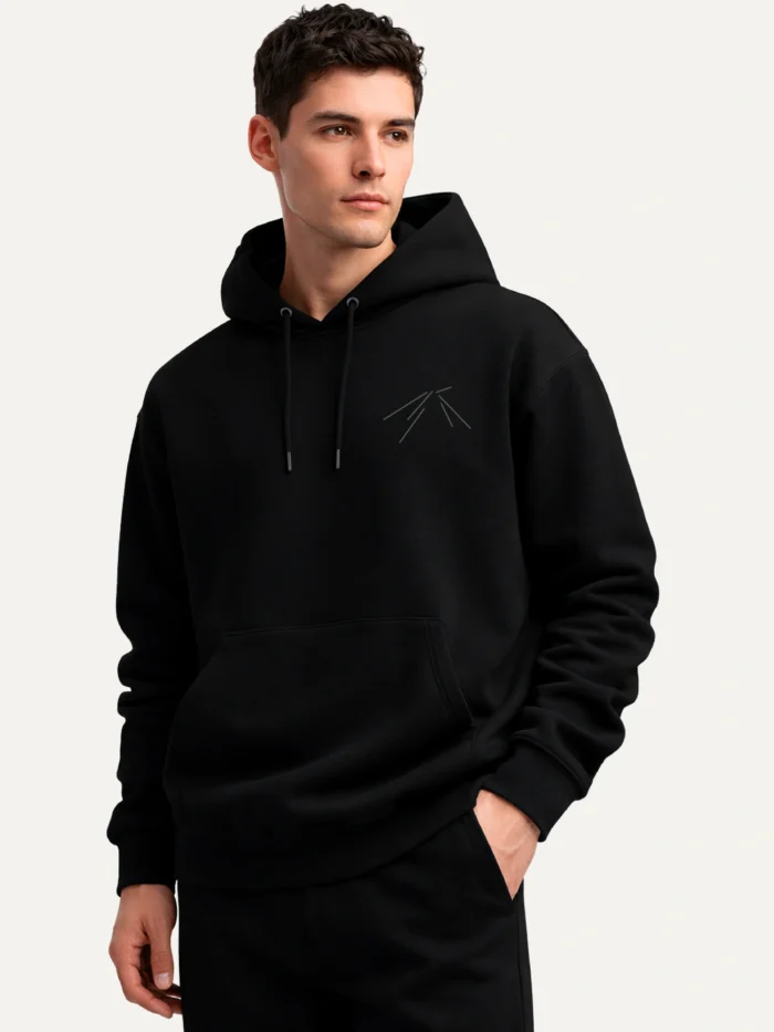 black organic hoodie angled view worn minimal chest design