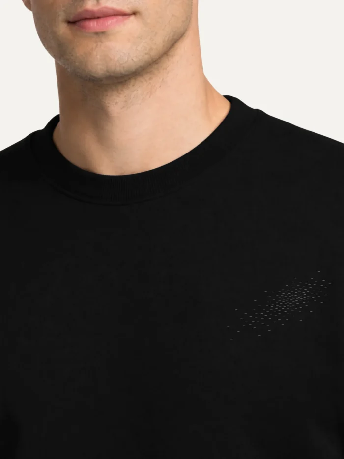 Black organic sweatshirt with small Camouflage Field artwork on chest