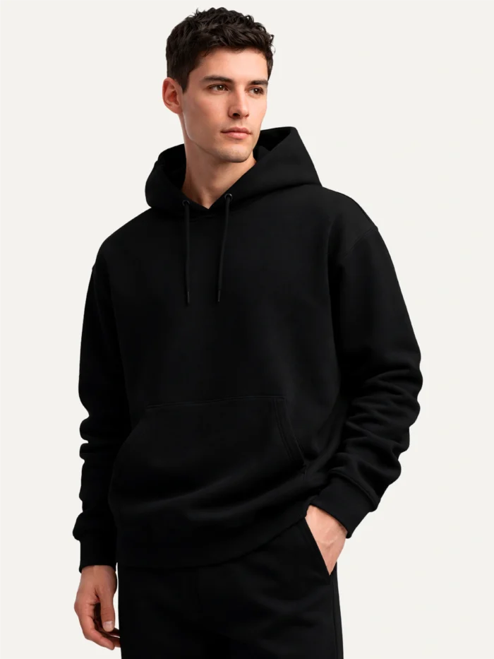 male-model-wearing-black-organic-hoodie-three-quarter-view
