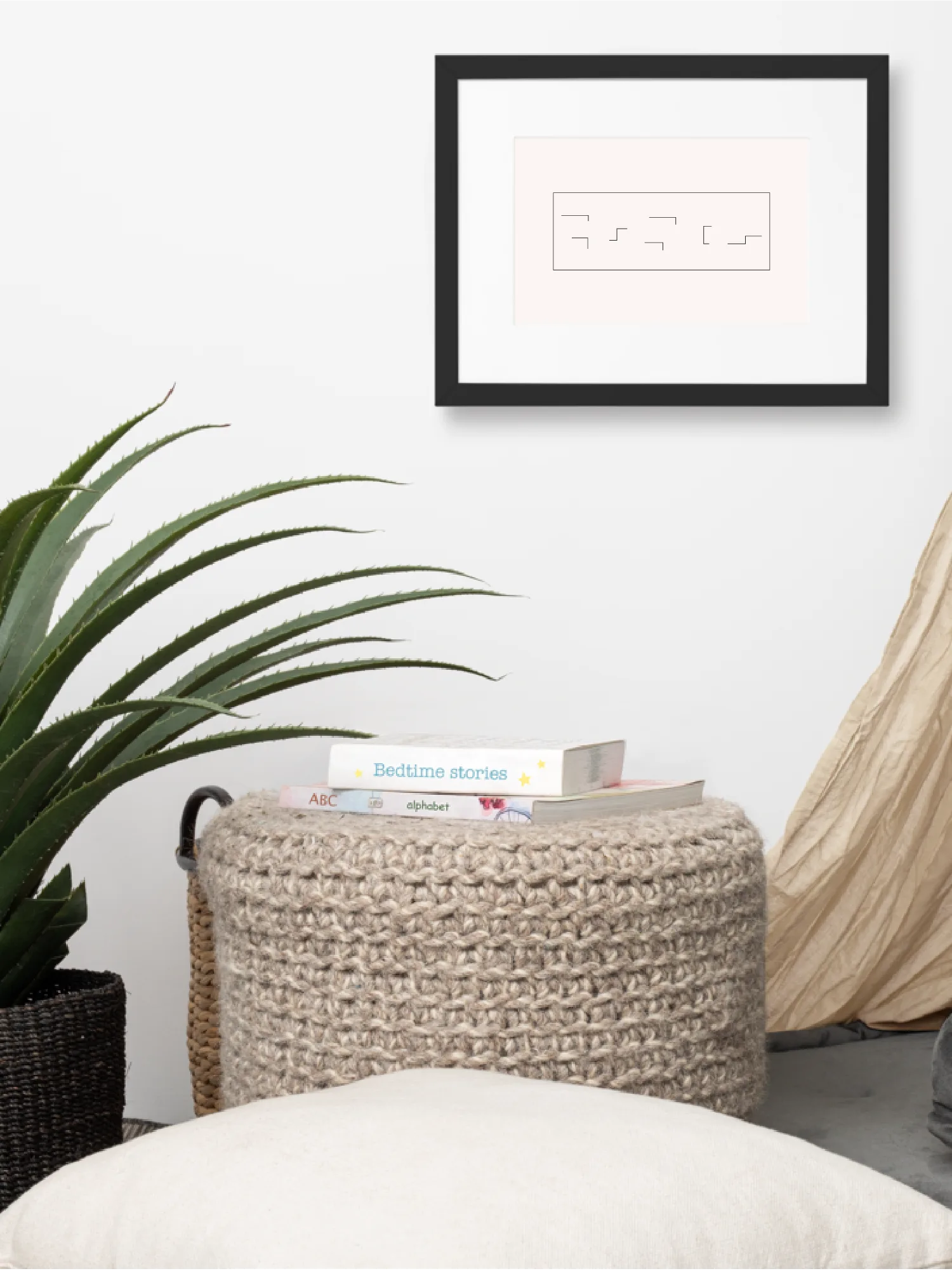 Held Insert framed art print displayed above a woven side stool