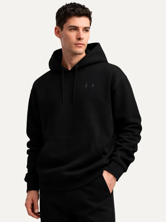 Three-quarter view of model wearing black Memory Relay organic cotton hoodie