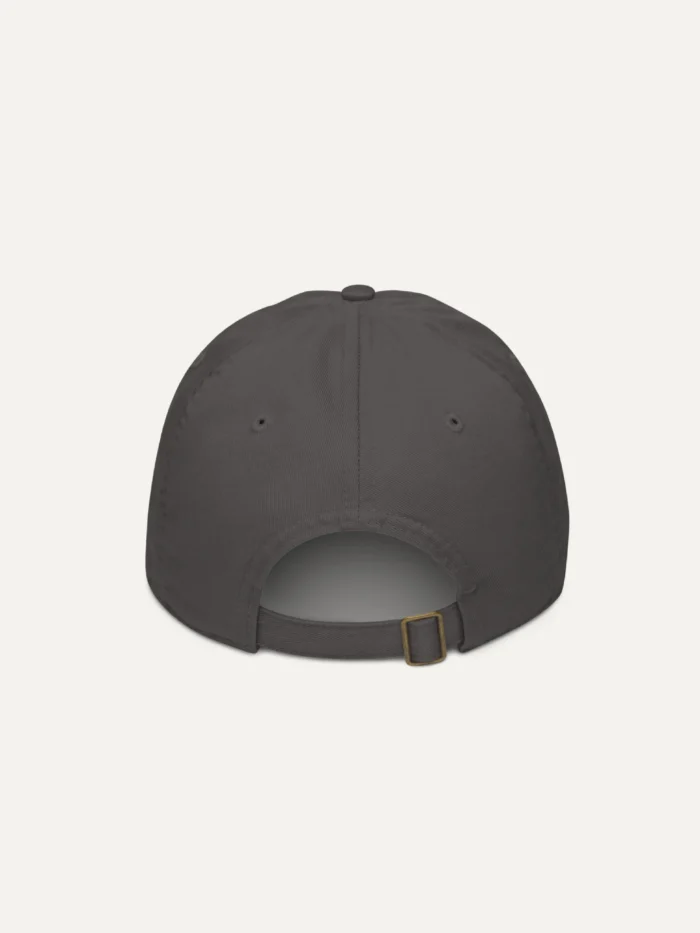 Displaced Ground Organic Cotton Twill Cap — Charcoal, back view with adjustable strap and brass slider.