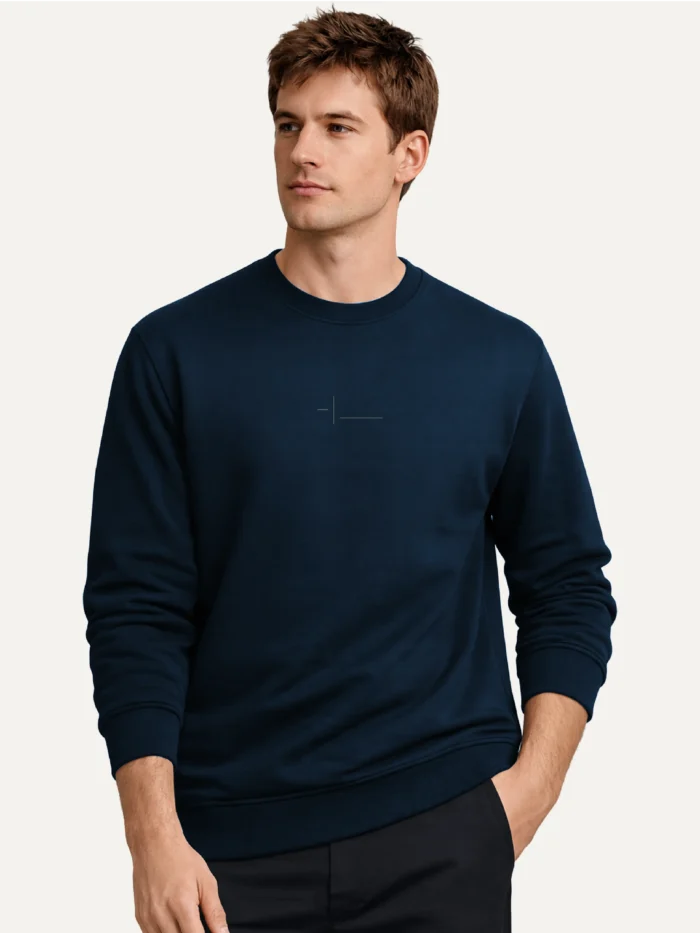 odel wearing the Displaced Ground Organic Cotton Sweatshirt — French Navy with centre-chest signal.