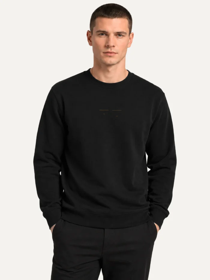 Model wearing black Return Interval organic cotton sweatshirt