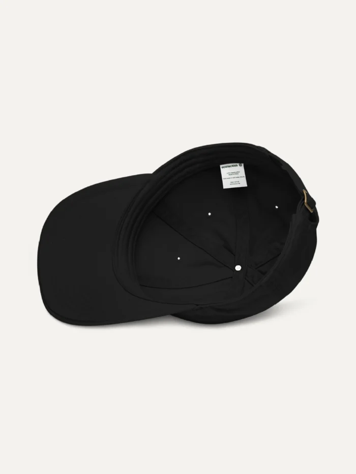Black organic cotton cap interior showing panel seams, sweatband and adjustable closure