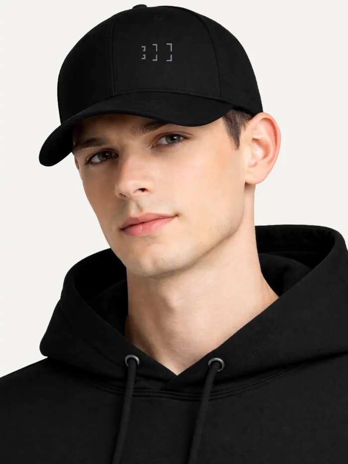 Model wearing Black Second Look cap with grey geometric embroidery