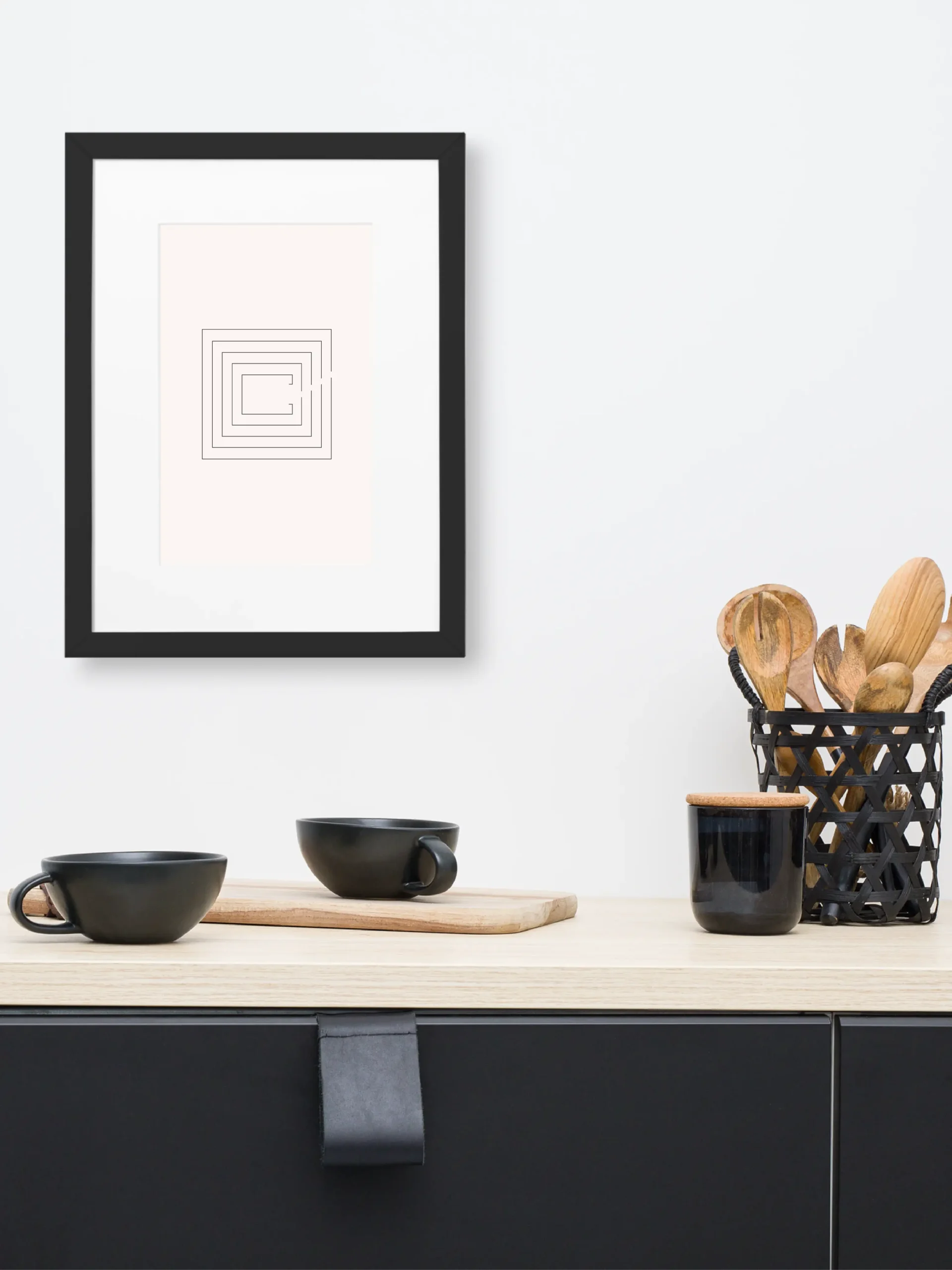 Second Look framed artwork above kitchen counter with black cups and wooden utensils